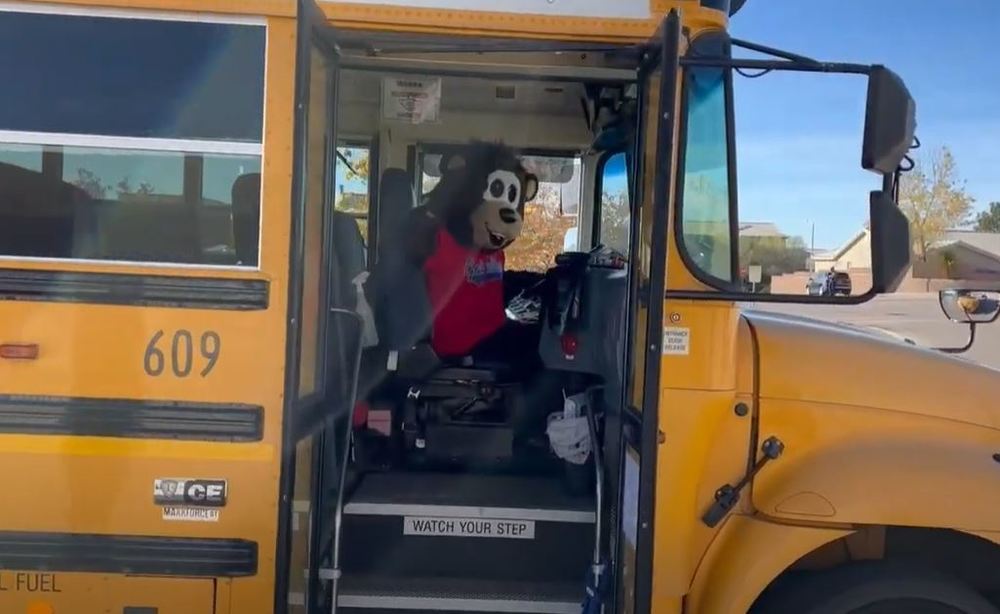 VGE Mascot "Elvis" takes the wheel in a school bus to get kids safely home after a school day