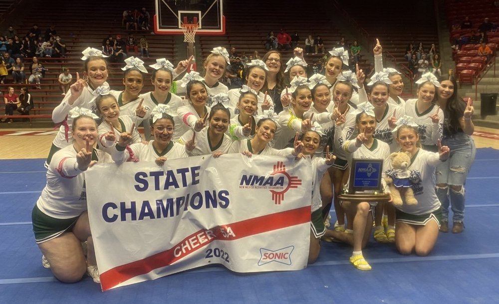 Photo of the entire RRHS Rams Cheer team holding a banner and winning trophy from the 2022 State Cheer Championships 