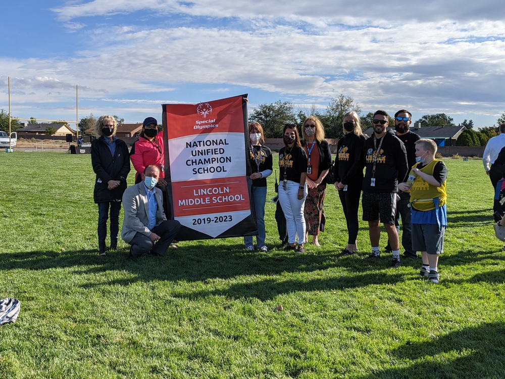 Lincoln Middle School accepts a National Unified School Champion banner from the Special Olympics