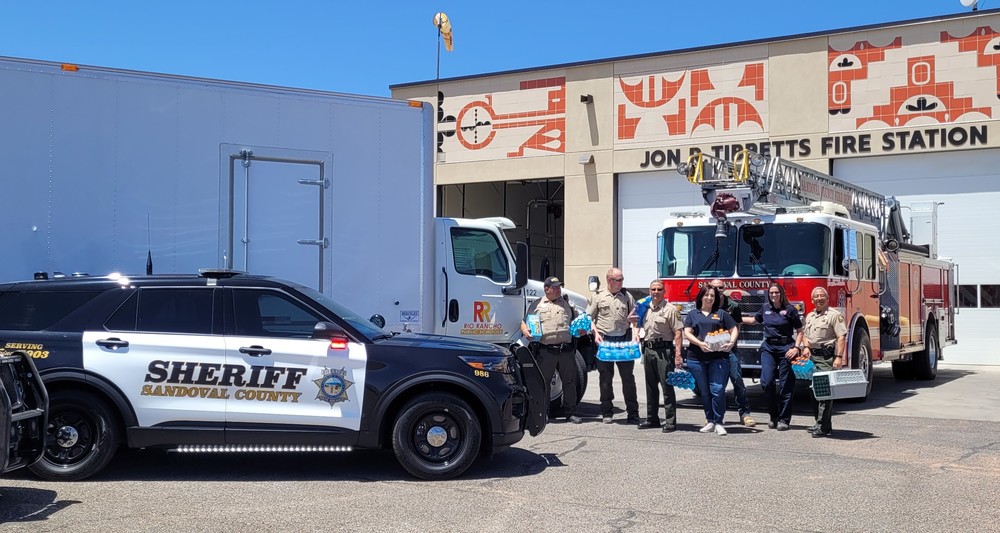 Representatives from the Sheriff's Office and Rio Rancho Public Schools pose with Wildfire Donations while delivering the items to the Fire Department on May 13, 2022
