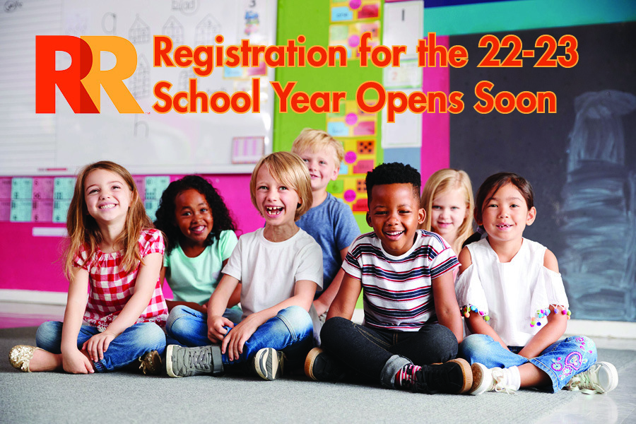 A group of children sitting on the floor in a classroom with the words "Registration for the 22-23 School Year Opens Soon" written above them.