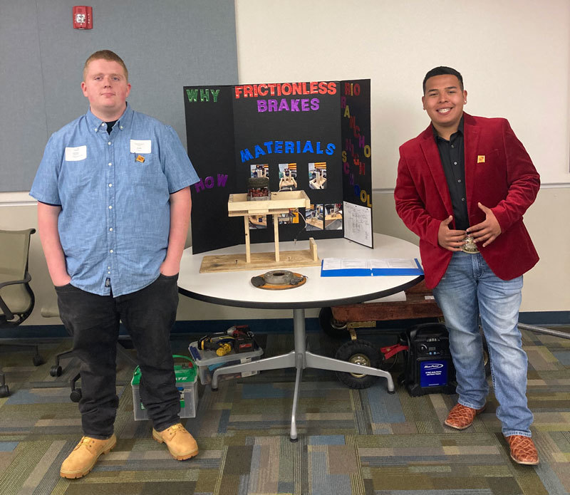Students M.Spillers and L.Mendoza pose with their project presentation at the Skills USA Competition