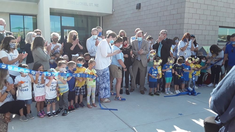 Students, staff, school board members and other special guests cut the official ribbon at Shining Stars Preschool.