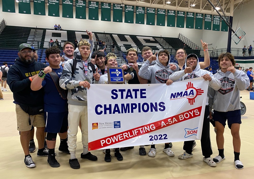 The RRHS powerlifting team poses with their championship banner