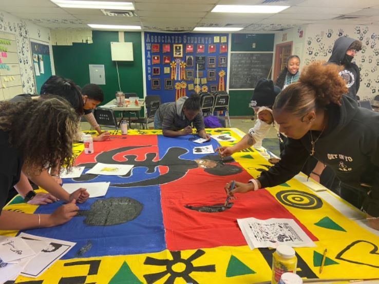Photo of students from the Black Student Union at Rio Rancho High School working on their mural.